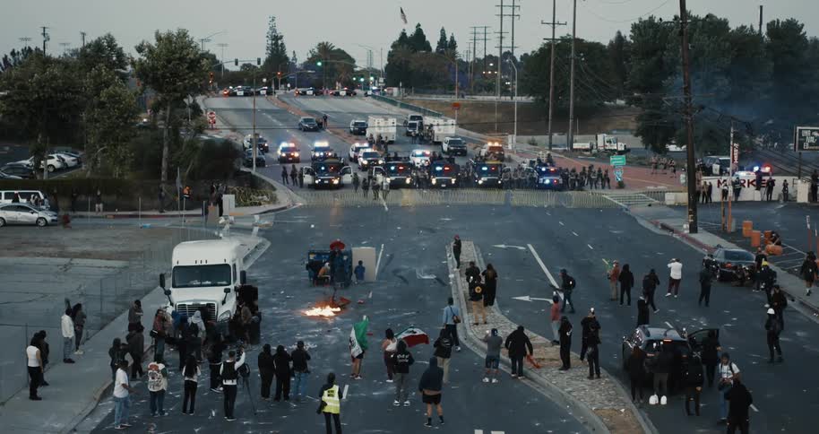 The protesters are throwing explosives as the police block the road