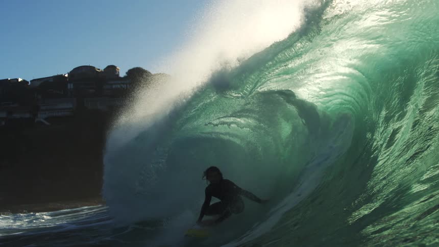 Person surfing a transparent wave