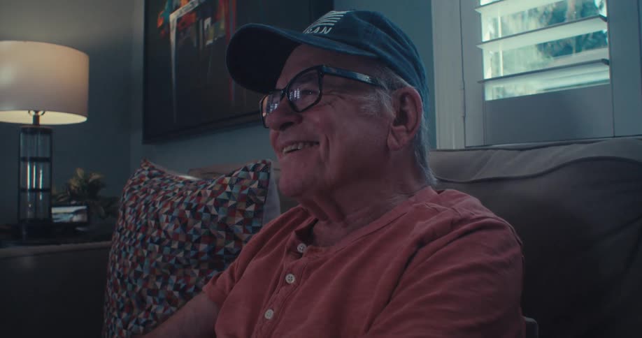 A man is enjoying watching television at home