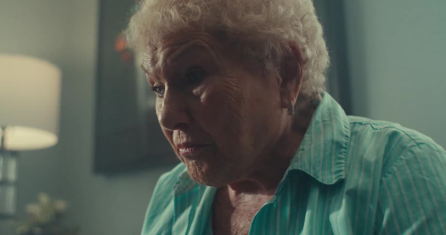 Elderly lady indoors staring straight ahead