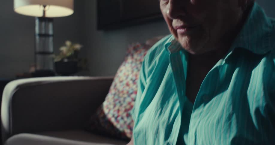 The woman is talking while looking at her tablet