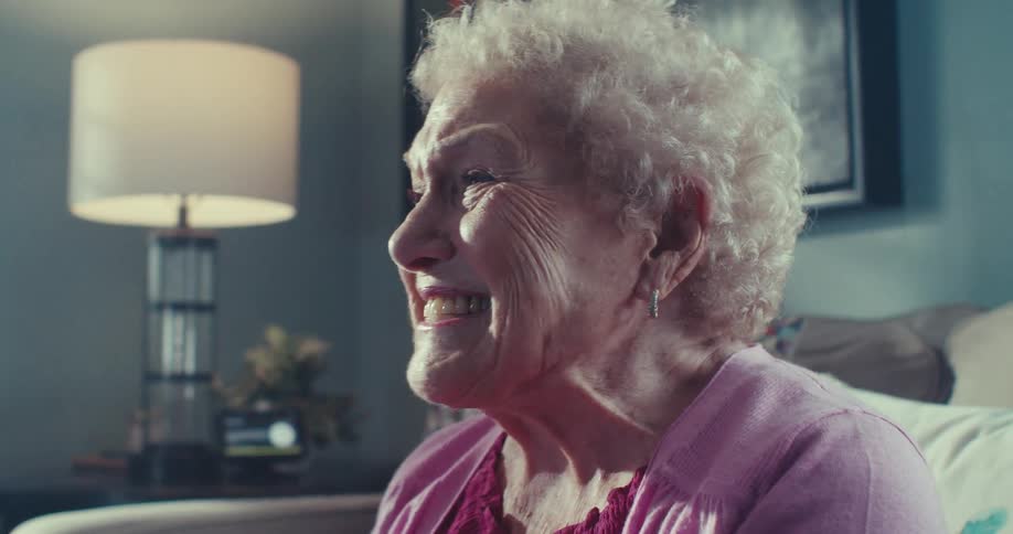 A woman is talking and laughing while clapping her hands