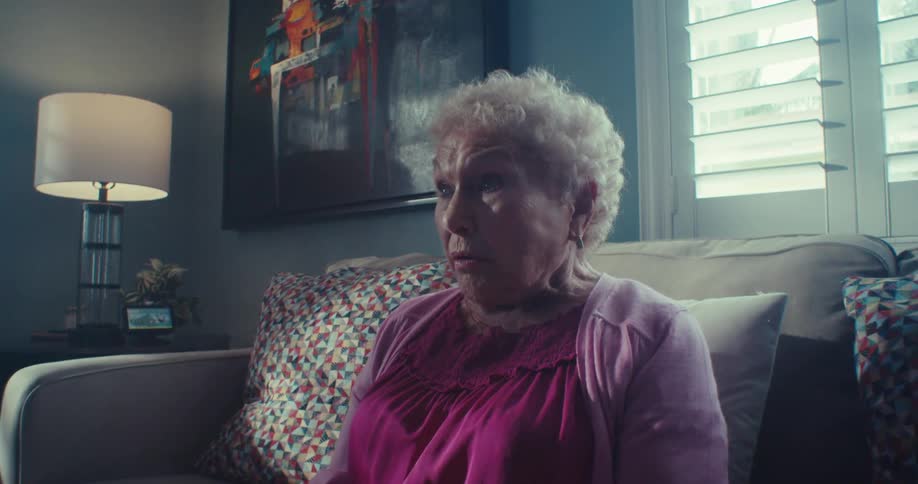 Elderly lady sitting on the sofa in the living room