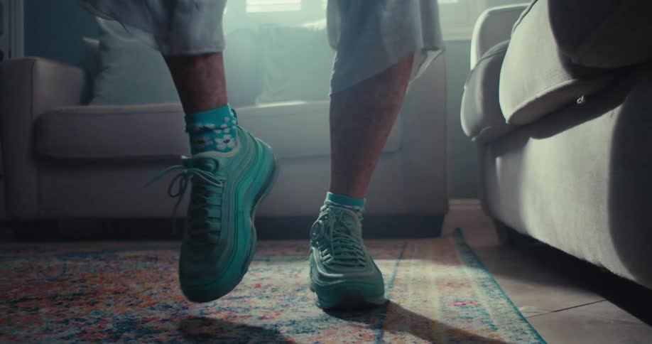 A person is dancing by the sofa