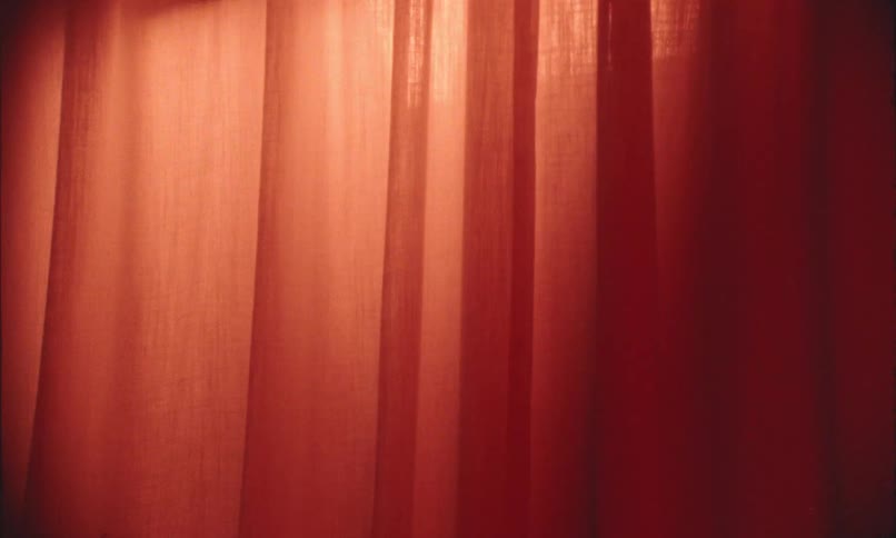 Light flashes on a red curtain