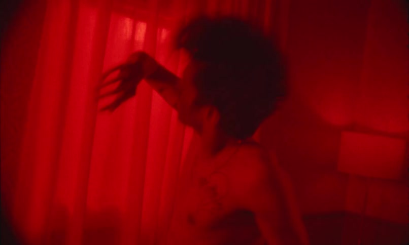 Man inside a room with red lighting dancing