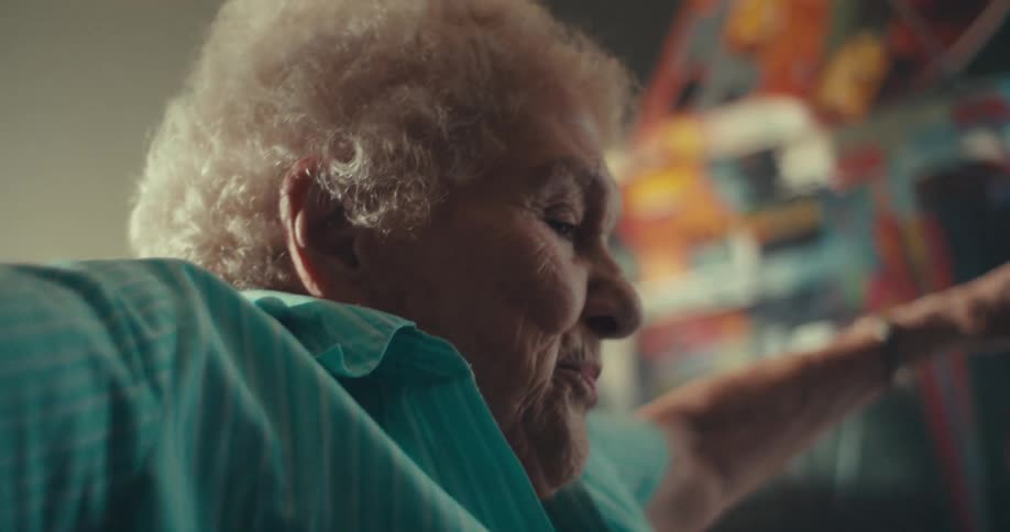 Elderly woman sings and dances in her living room