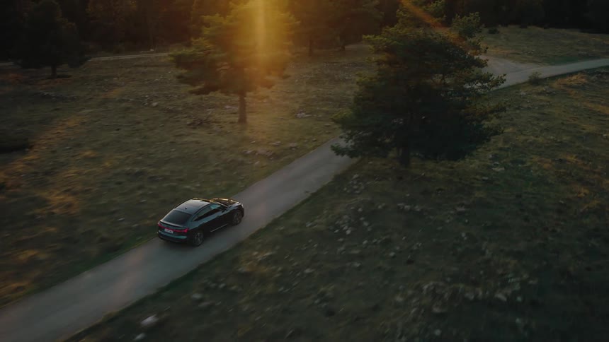 A car drives down a winding road