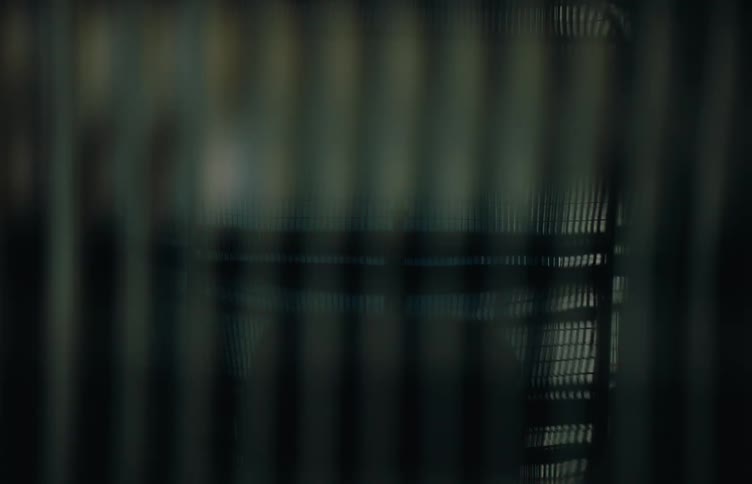 A car is passing by under the grate