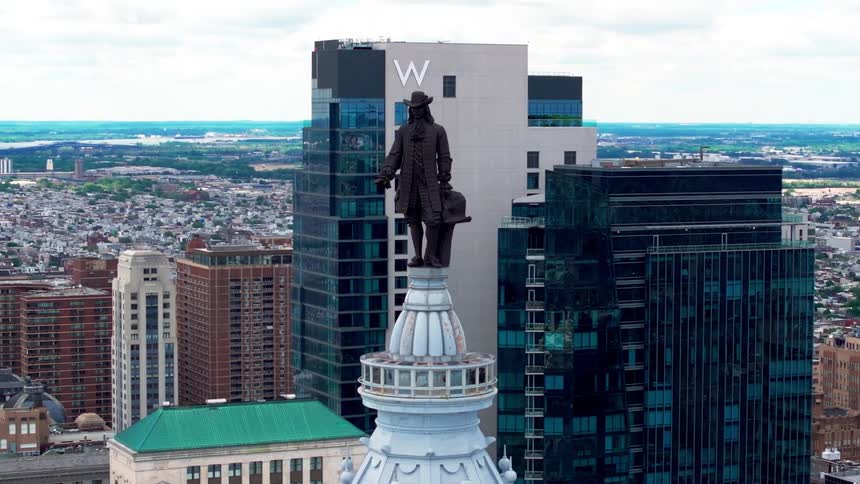 Orbiting aerial view of Philadelphia City Hall and William Penn statue