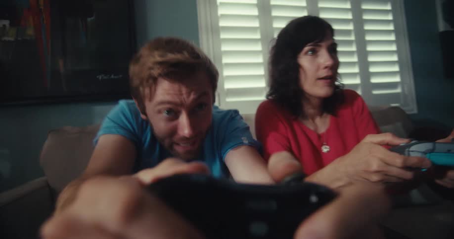 Two people are being competitive while playing video games