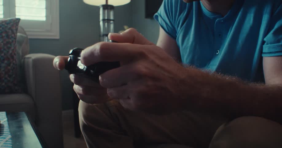 A man is mashing the buttons on the video game controller