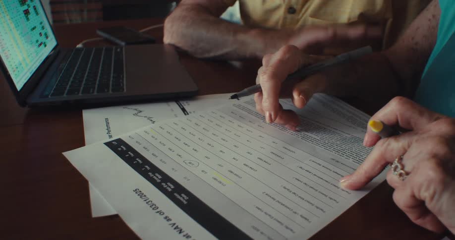 Person holding a pen on a document