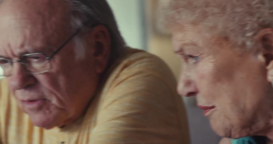 A man is pointing at something and talking with a woman