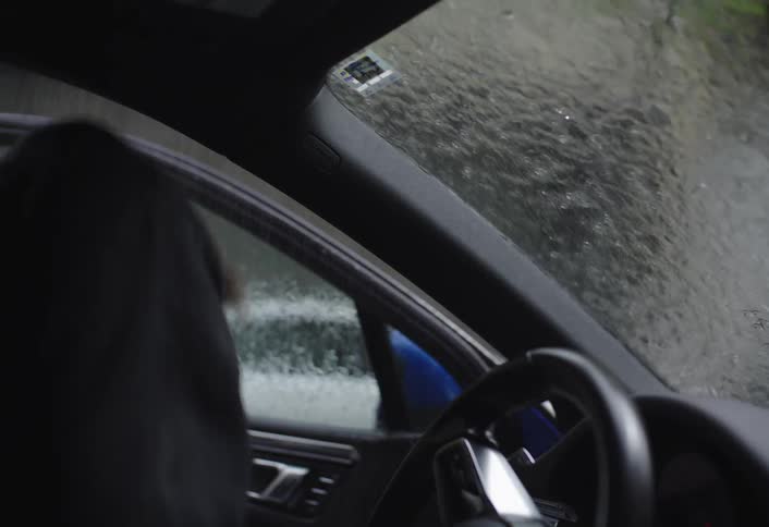 The man runs through the rain to enter his car