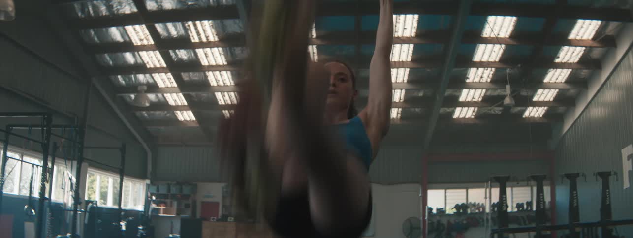 Woman holding a hoop doing gymnastics and then checking her hands