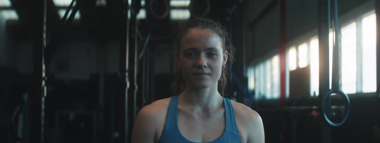 Portrait of a woman in a blue top in a gym