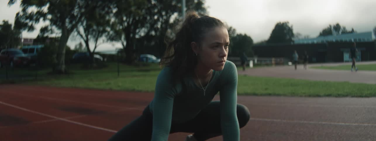 The woman is stretching on the track