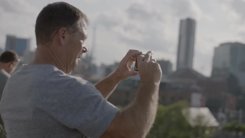 People are taking pictures of a city on a cloudy day
