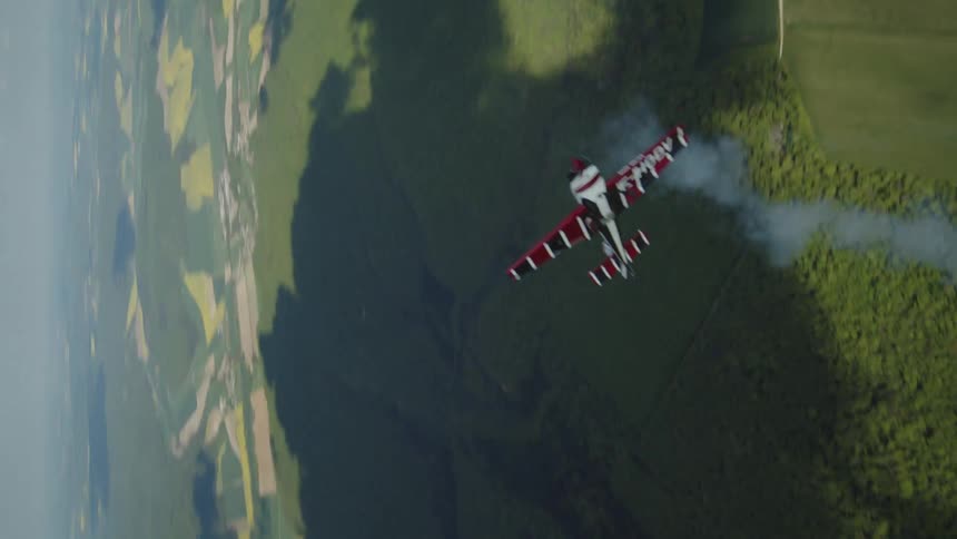 Small plane performing aerial maneuvers during the day