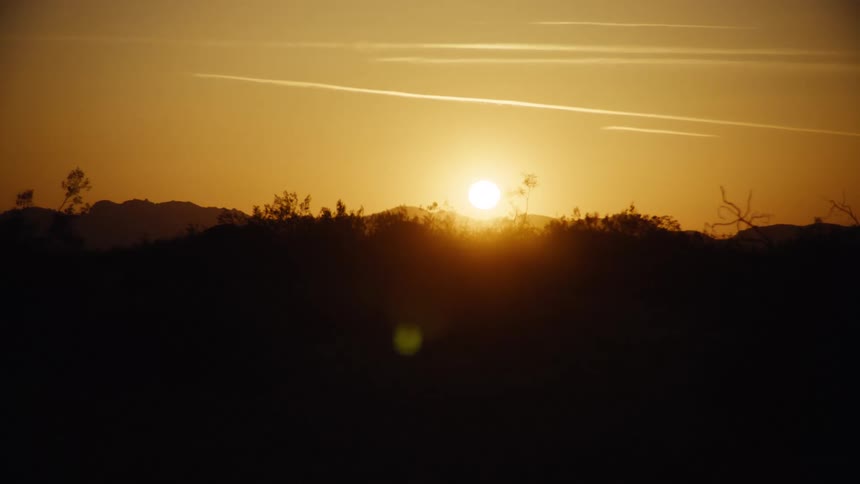 The sky is yellow as the sun rises