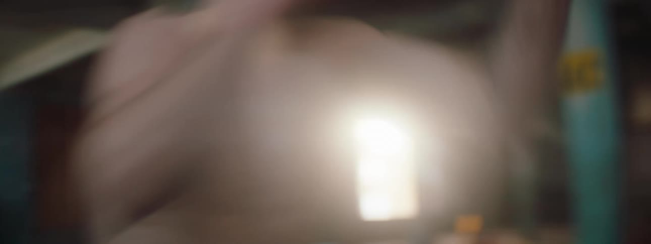 A shirtless man is shadowboxing