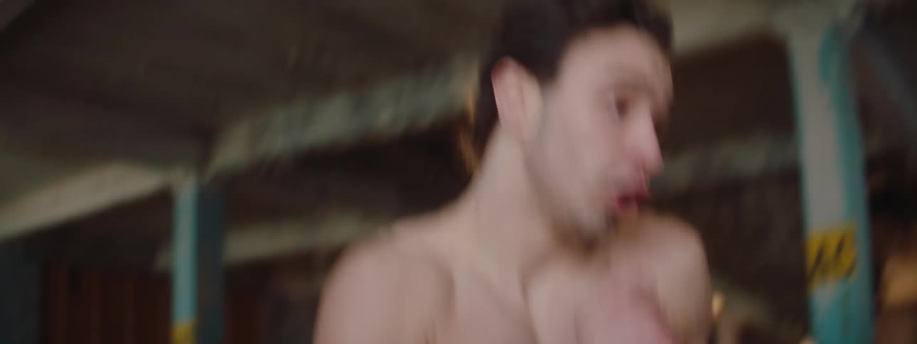 A man is punching and kicking in the loft
