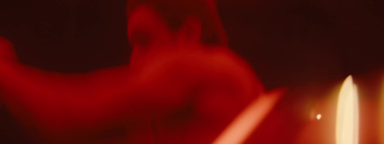 The man is shadowboxing in the dark room