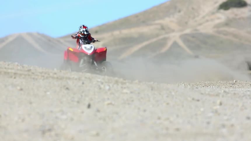 Man riding a four wheeler in the desert