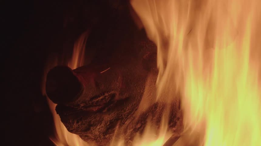Pig head burns in a roaring fire