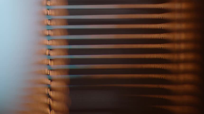 Shadow and light reflect on window blinds