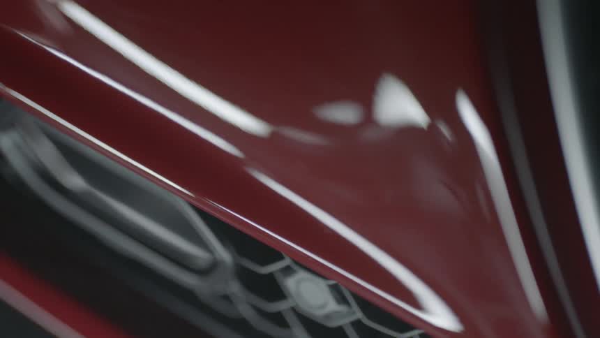Light reflects off a red car