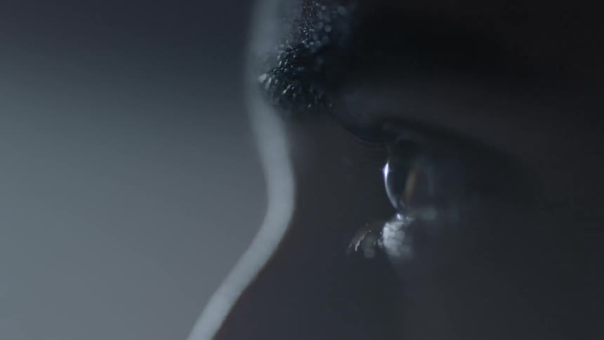 A person stares towards a bright light