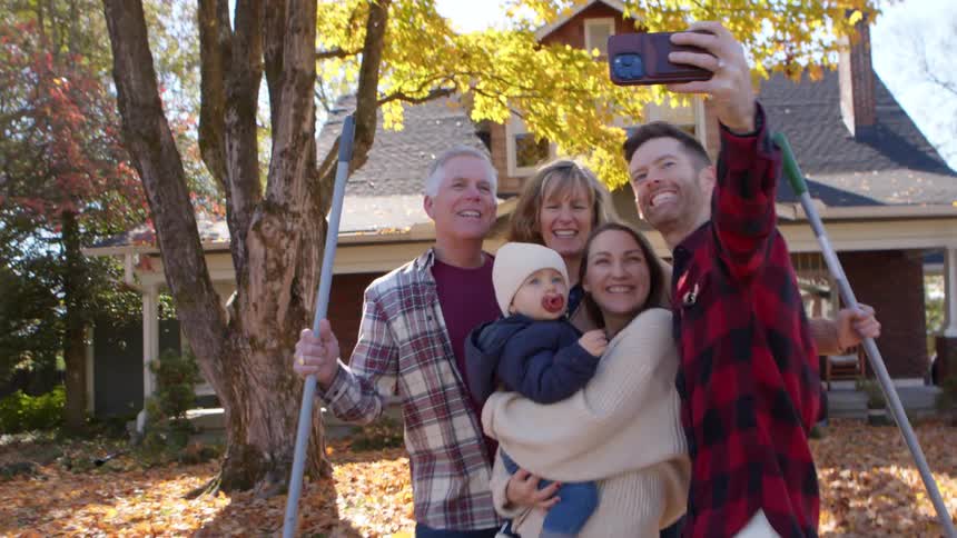 Family gathered in a backyard taking a happy selfie