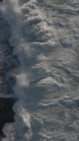 The rough waters are crashing on the sand