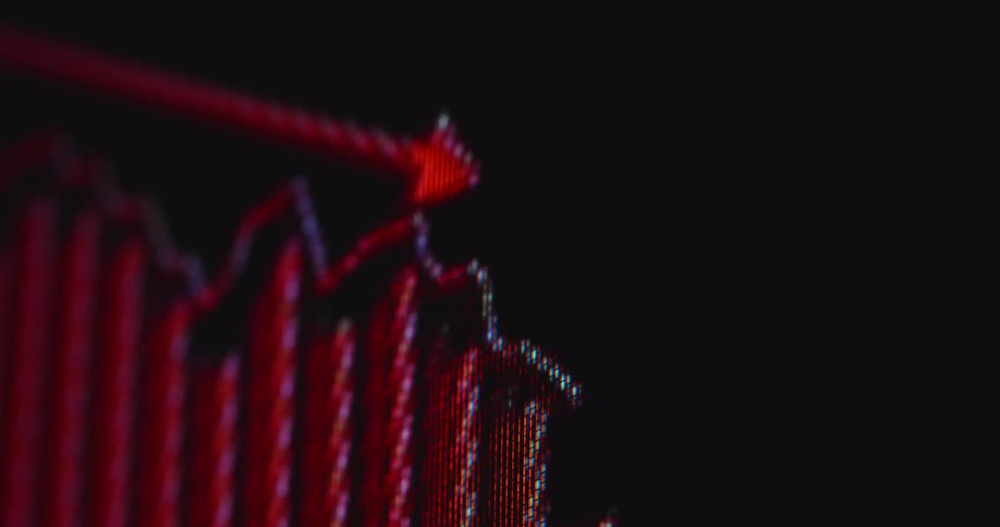 Dramatic macro shot of pixelated computer monitor showing a trading chart or financial graph crashing as the global economy is hit by a recession causing great depression and panic sales at the financial markets