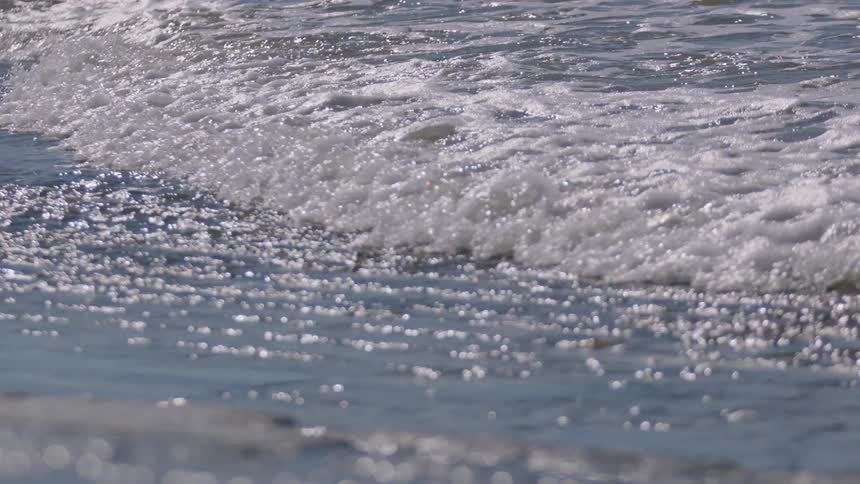 Waves flow onto the shoreline