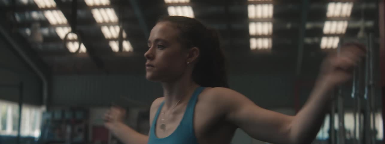 Woman jumps rope in the gym during the daytime