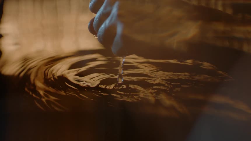 Person lifting fist out of a pool of water