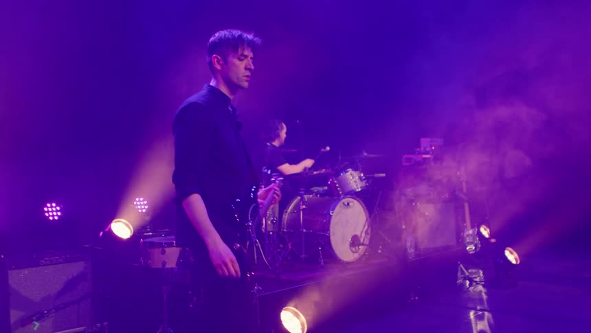 Rock band performs on a hazy stage