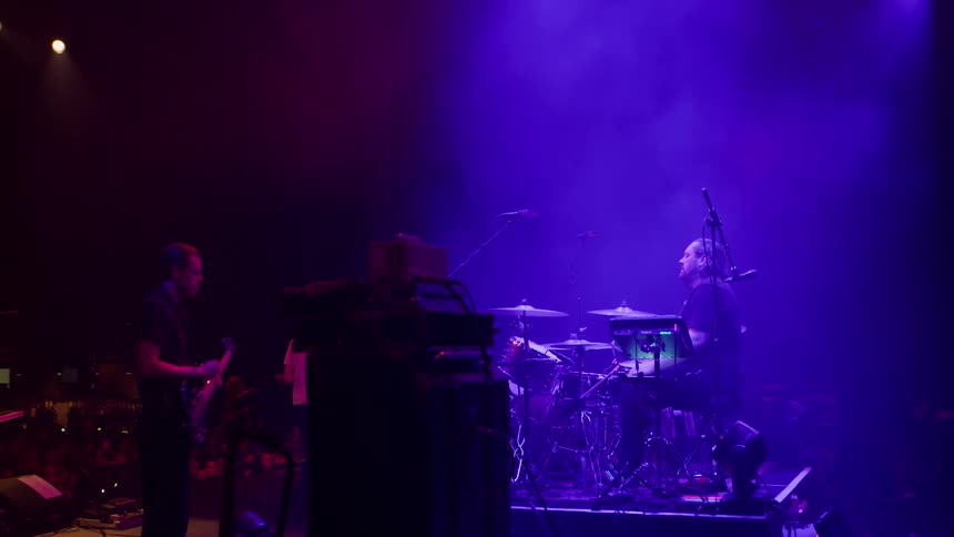 Audience claps after the solo performance of the drummer in a rock band