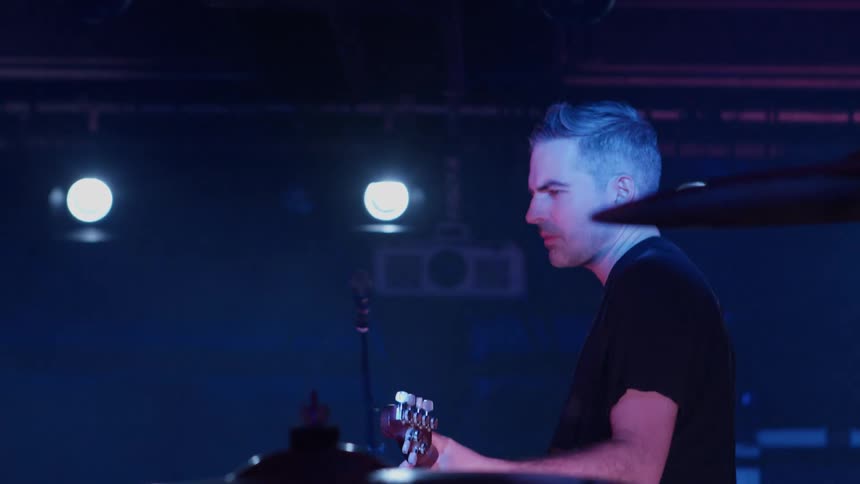 Man in a performance playing guitar