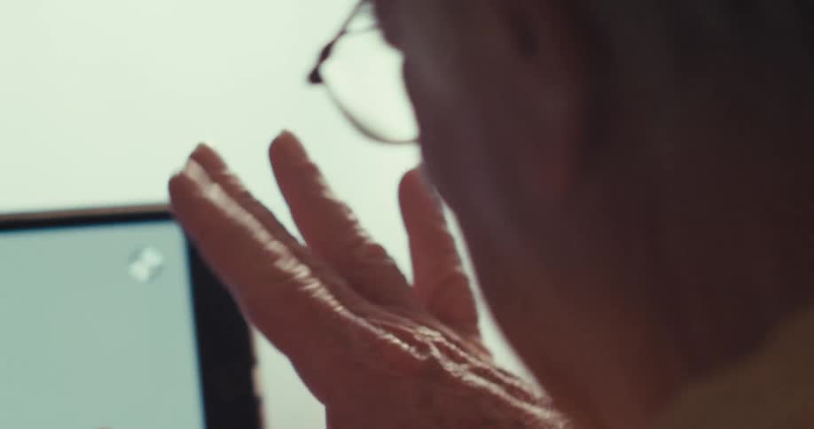 People holding hands interacting in front of a tablet