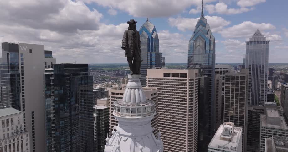 Aerial view of William Penn atop Philadelphia city hall surrounded by skyscrapers