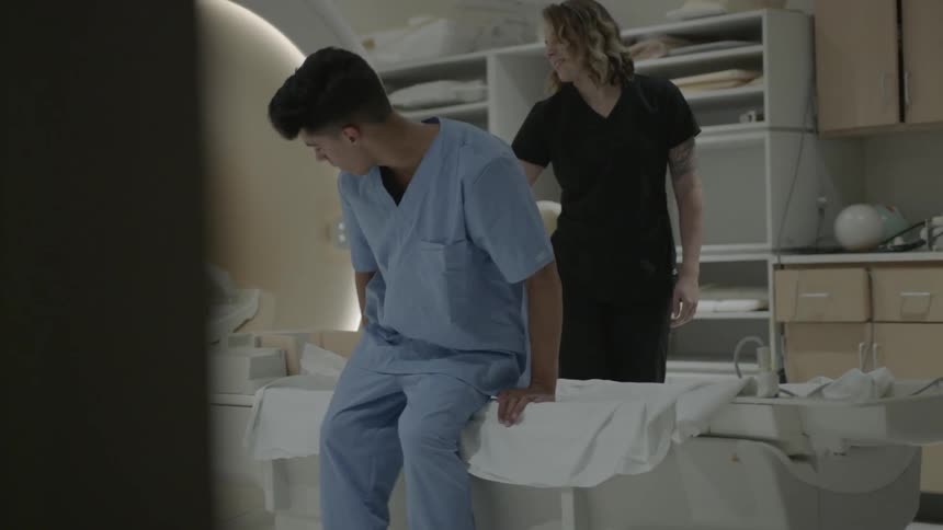 A patient greets the technician then lies on the mri table