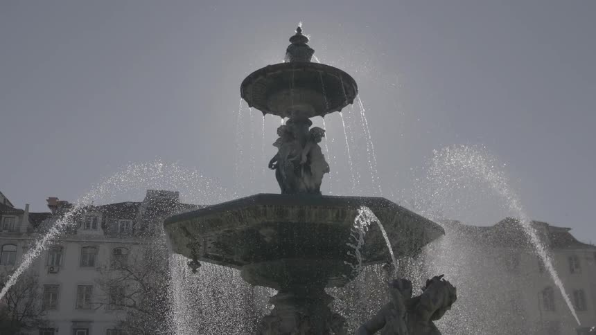 Fountain splashing water down its sides with water spraying at it
