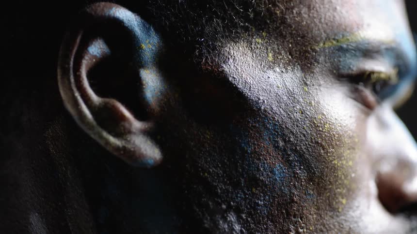 A person's face is covered with paint