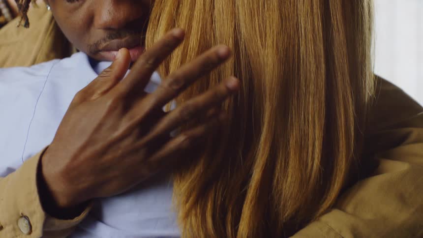 Man and woman hugging each other affectionately