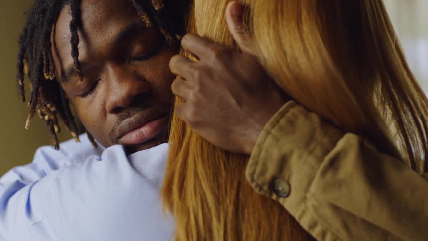 Two people hugging each other affectionately