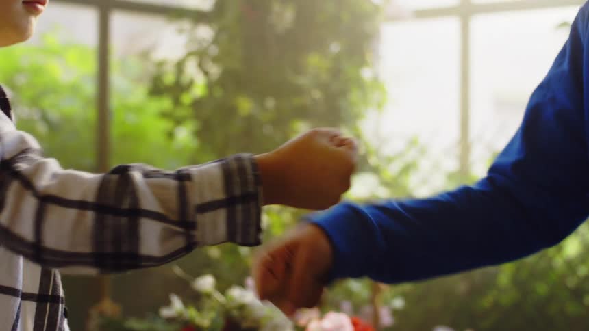 Two children greeting each other with hand gestures